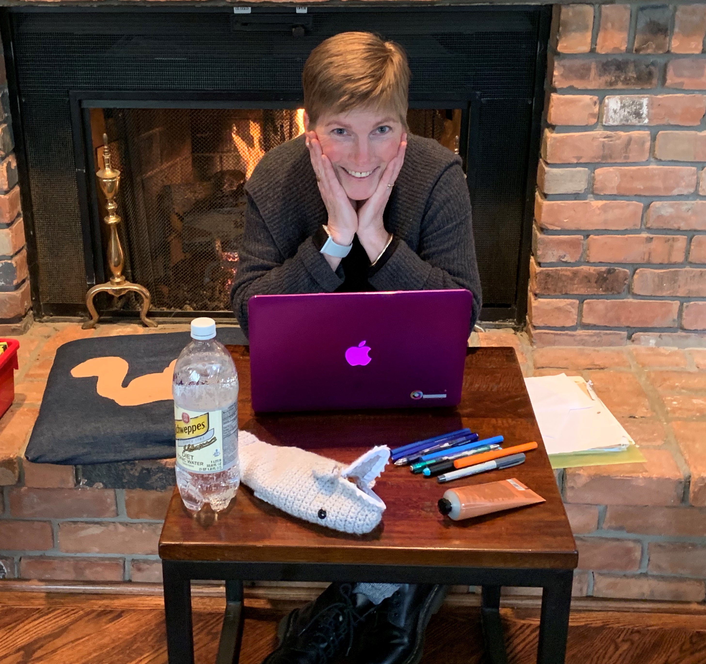 Amy Hermon with Apple laptop on table