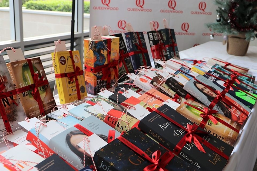 Table covered in books wrapped as gifts.